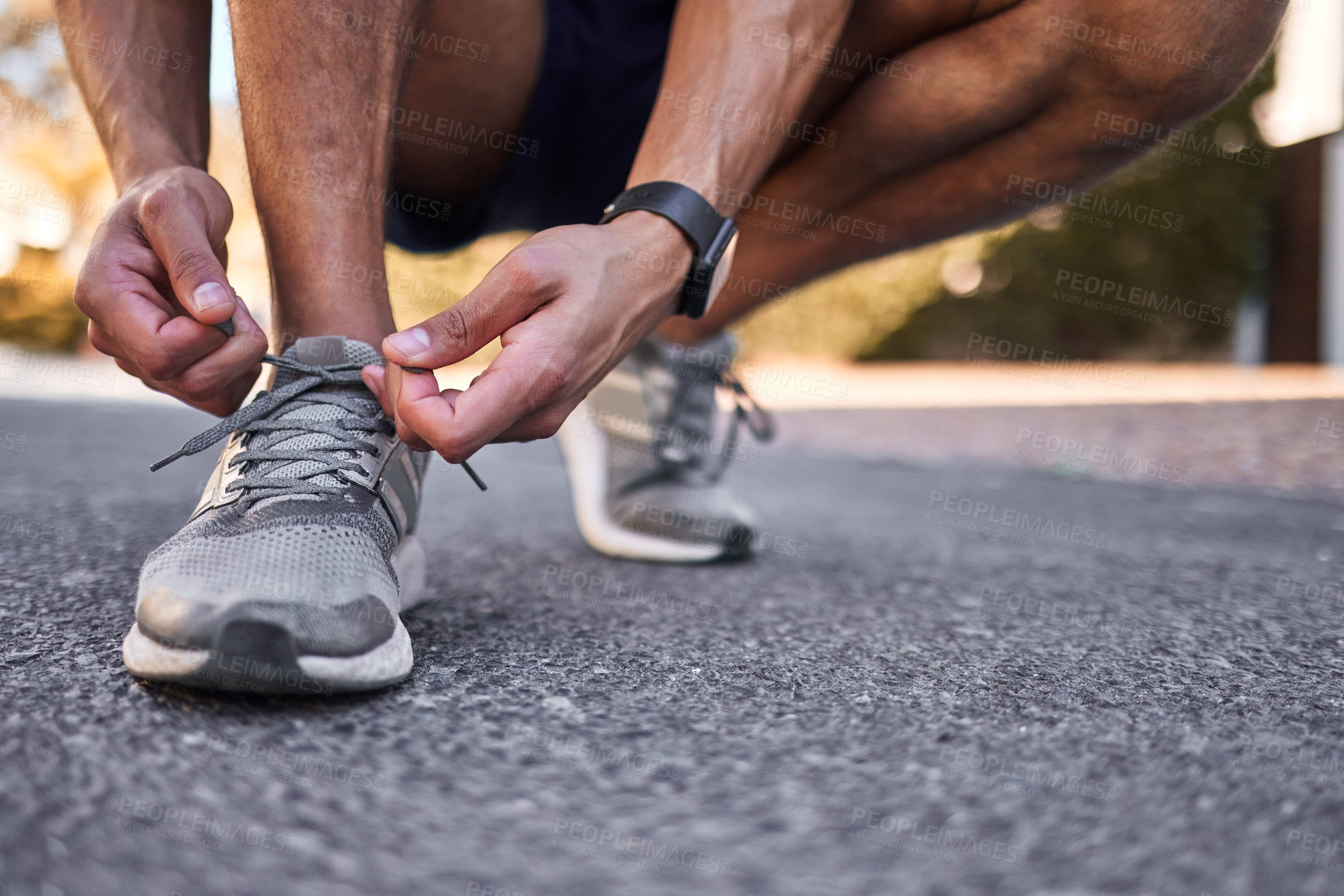 Buy stock photo Athlete, shoelaces and hands for man runner, workout and nature for cardio exercise. Legs, footwear and sports outdoors or trail run, performance and training for health or marathon preparation
