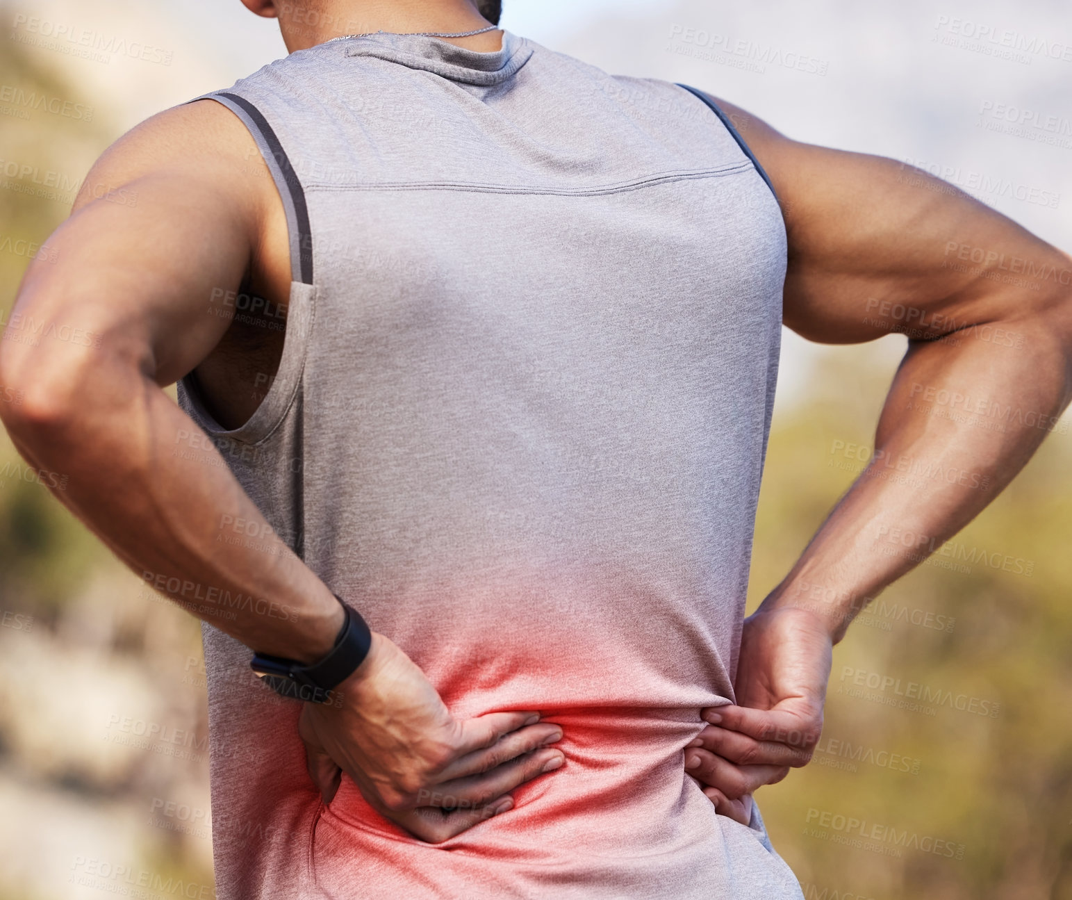 Buy stock photo Cropped shot of an unrecognizable man standing alone outside and suffering from backache during his run