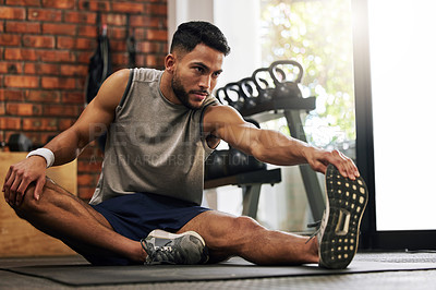 Buy stock photo Gym, man and stretching legs for warm up, training motivation and fitness mindset for workout with hand on foot. Focus, commitment and male athlete on floor to stretch at sports club for exercise
