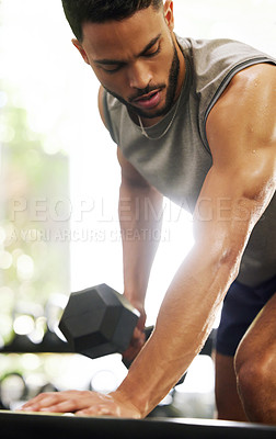Buy stock photo Exercise, weightlifting and man with dumbbell in gym for fitness, bodybuilder training and workout. Sports, strong muscles and serious male person lift weights for wellness, healthy body and strength