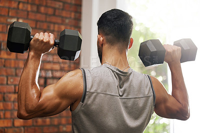 Buy stock photo Weightlifting, muscle and man with dumbbell in gym for exercise, bodybuilder training and workout. Sports, fitness and back of strong male person lift weights for wellness, healthy body and strength