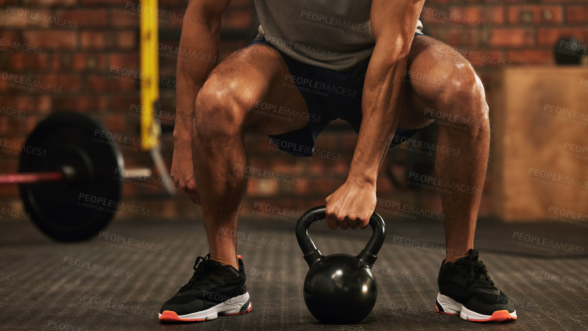 Buy stock photo Sports, kettlebell and male athlete doing a workout in the gym for strength, health and motivation. Fitness, strong and closeup of a man doing an arm exercise with weights and squats in sport center.