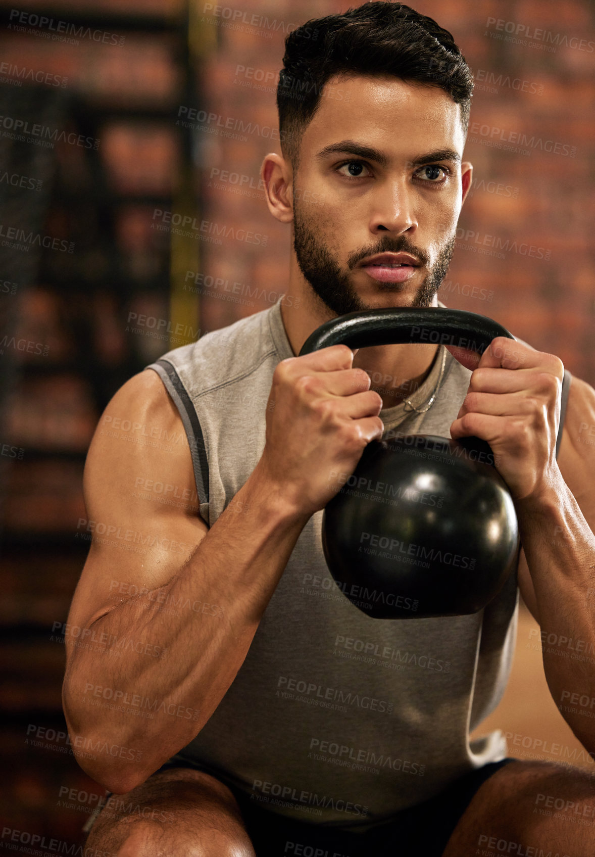 Buy stock photo Weightlifting, training and man with kettle bell in gym for exercise, bodybuilder and fitness workout. Sports, muscle and serious male person squat with weight for wellness, healthy body and strength