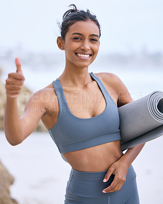 Buy stock photo Woman, thumbs up and yoga at beach with smile for wellness, winner mindset for exercise. Indian female or instructor with hand sign by ocean for zen, motivation in nature for health or happiness
