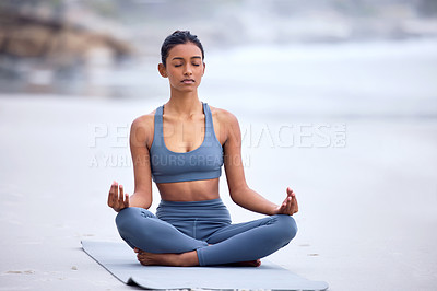 Buy stock photo Calm woman, yoga and beach mediation with lotus pose for wellness, zen mindset and spiritual balance. Female athlete, fitness and peace to meditate, relax and breathe for mental health in nature 