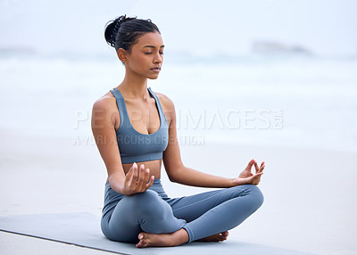Buy stock photo Yoga, lotus meditation and Indian girl at beach for mindfulness, peace or relax on mockup space. Zen, ocean and woman in padmasana pose for exercise, fitness and wellness for body healthy outdoor