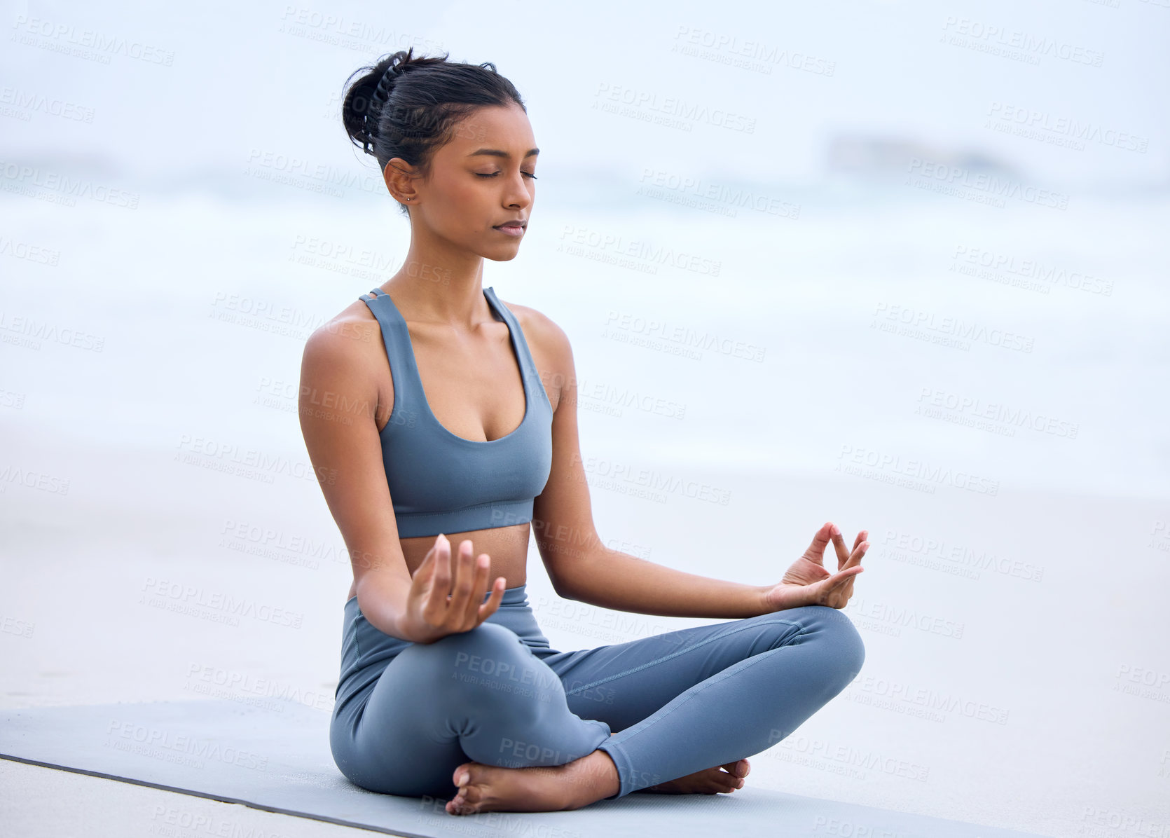 Buy stock photo Yoga, lotus meditation and Indian girl at beach for mindfulness, peace or relax on mockup space. Zen, ocean and woman in padmasana pose for exercise, fitness and wellness for body healthy outdoor