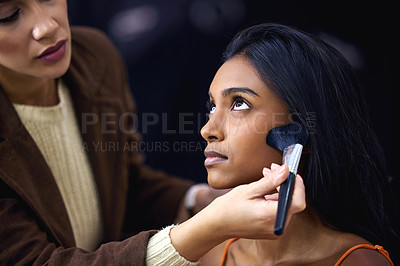 Buy stock photo Shot of a young woman having her blush touched up during a photo shoot