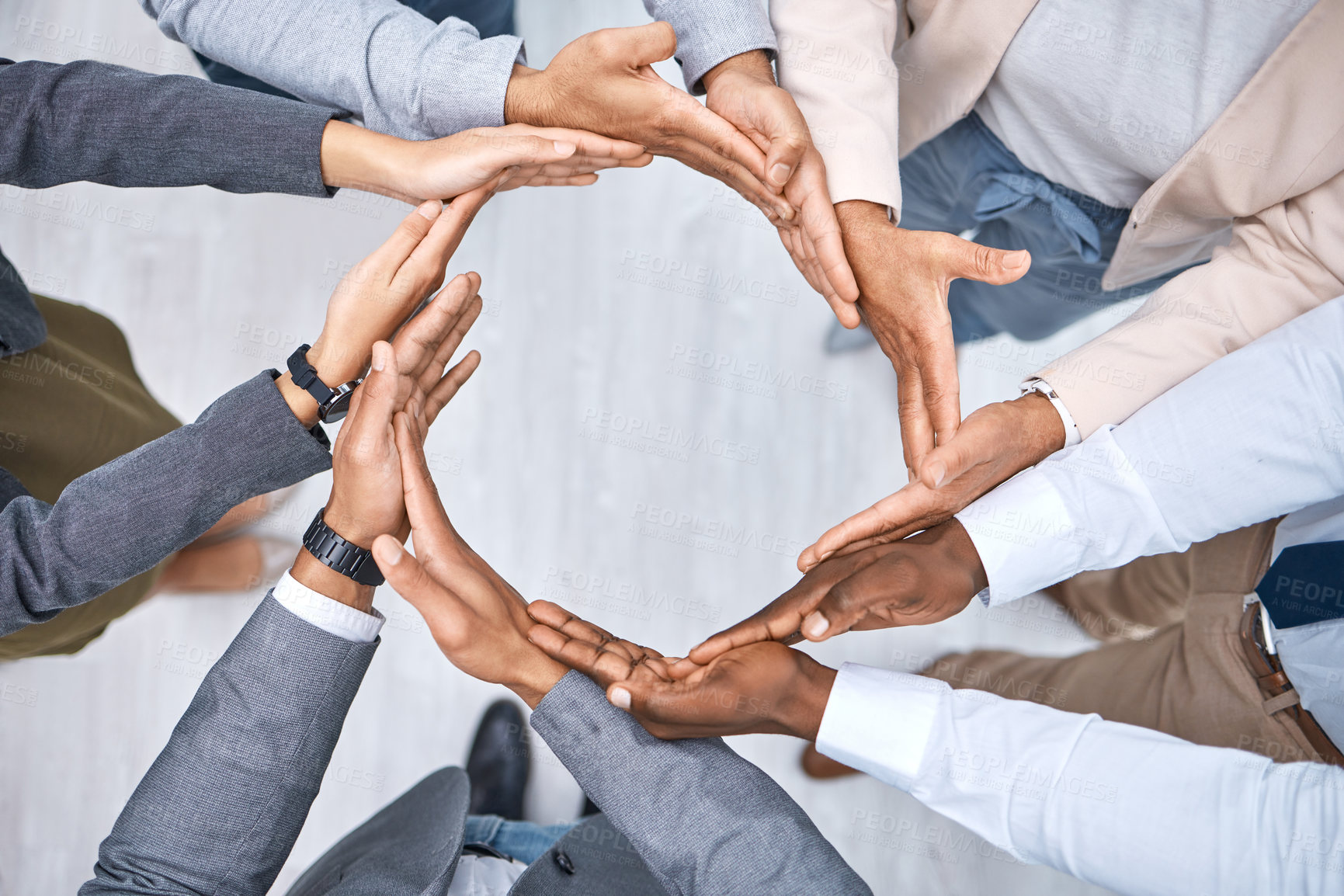 Buy stock photo Shot of a group of businesspeople joining their hands to form a circle