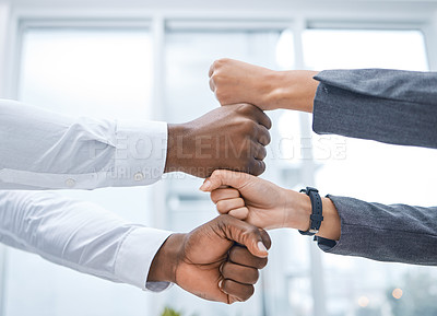 Buy stock photo Shot of two businesspeople stacking their fists on top of each other