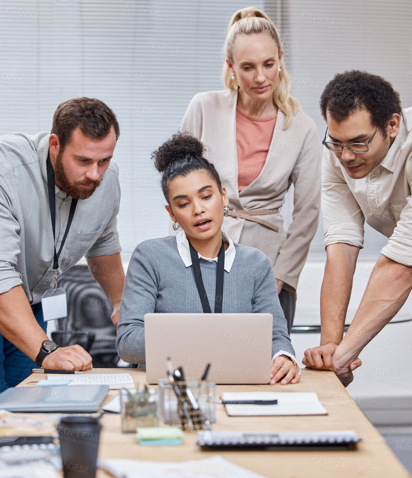 Buy stock photo Shot of a diverse group of businesspeople having a meeting in the office and using a laptop