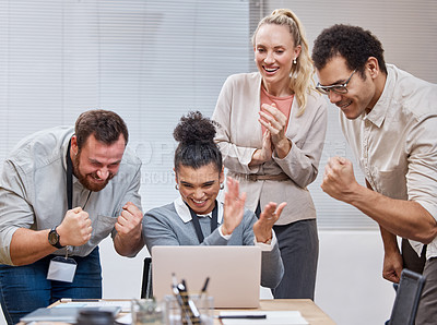 Buy stock photo Shot of a diverse group of businesspeople using a laptop and celebrating a success during a meeting in the office