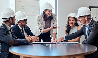 Buy stock photo Shot of a group of architects brainstorming in an office