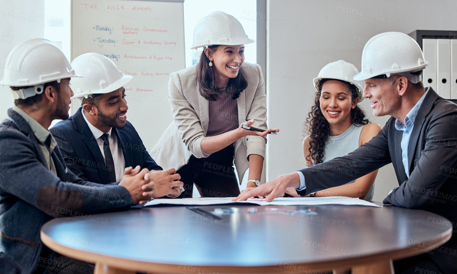 Buy stock photo Shot of a group of architects brainstorming in an office