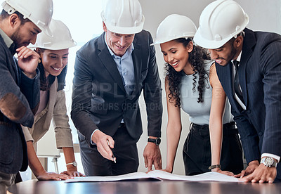 Buy stock photo Shot of a group of architects brainstorming in an office