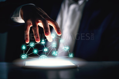 Buy stock photo Cropped shot of an unrecognizable businessman working alone in the office at night and using a digital tablet
