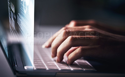 Buy stock photo Cropped shot of an unrecognizable businesswoman sitting alone in her office at night and using her laptop