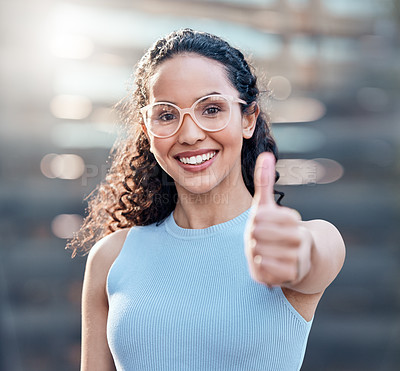 Buy stock photo Shot of an attractive young businesswoman standing alone outside and showing a thumbs up