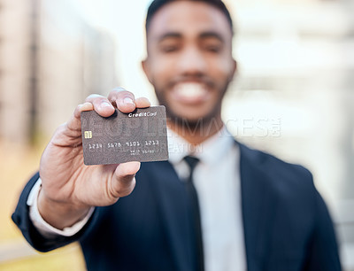 Buy stock photo Shot of an unrecognizable businessman standing alone outside and holding his credit card
