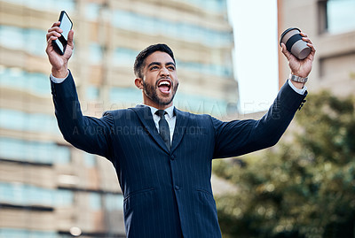 Buy stock photo Shot of a handsome young businessman standing alone outside and celebrating a success