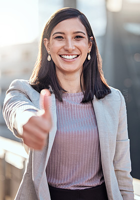 Buy stock photo Shot of an attractive young businesswoman standing alone outside and showing a thumbs up