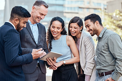 Buy stock photo Shot of a diverse group of businesspeople standing outside together and using a digital tablet
