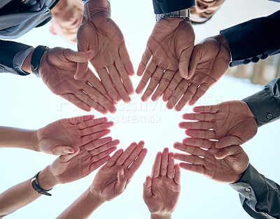 Buy stock photo Shot of a group of unrecognizable businesspeople putting their hands together in a circle