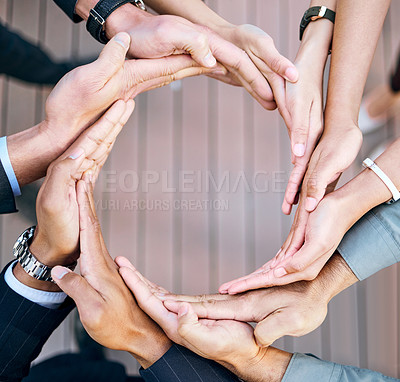 Buy stock photo High angle shot of a group of unrecognizable businesspeople forming a circle with their hands at work
