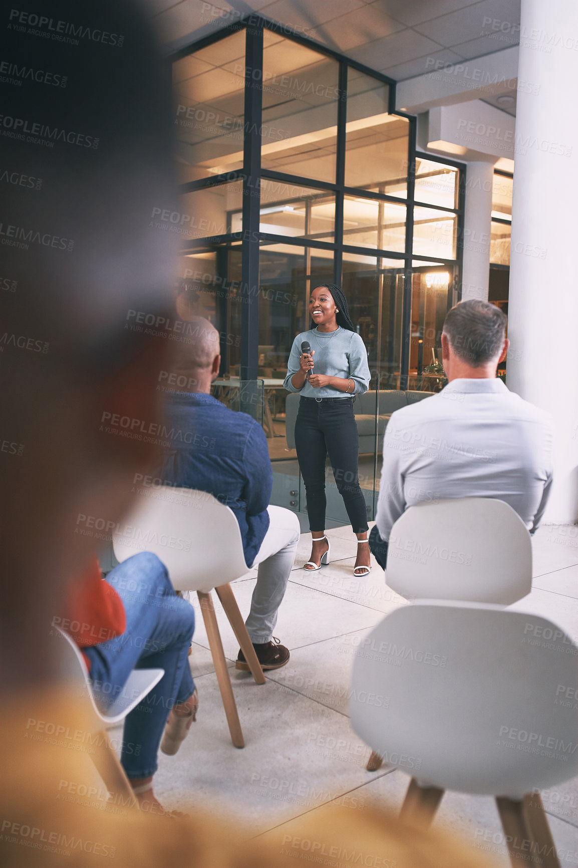 Buy stock photo Shot of a young businesswoman talking during a conference at work