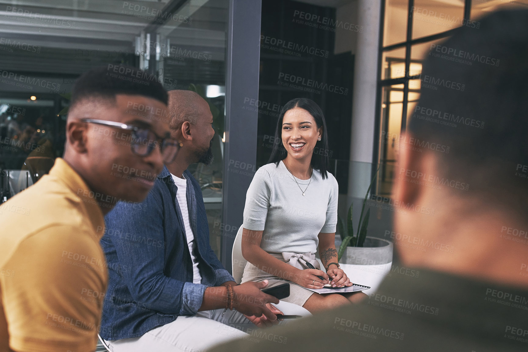 Buy stock photo Shot of a team of business people sitting together during a meeting