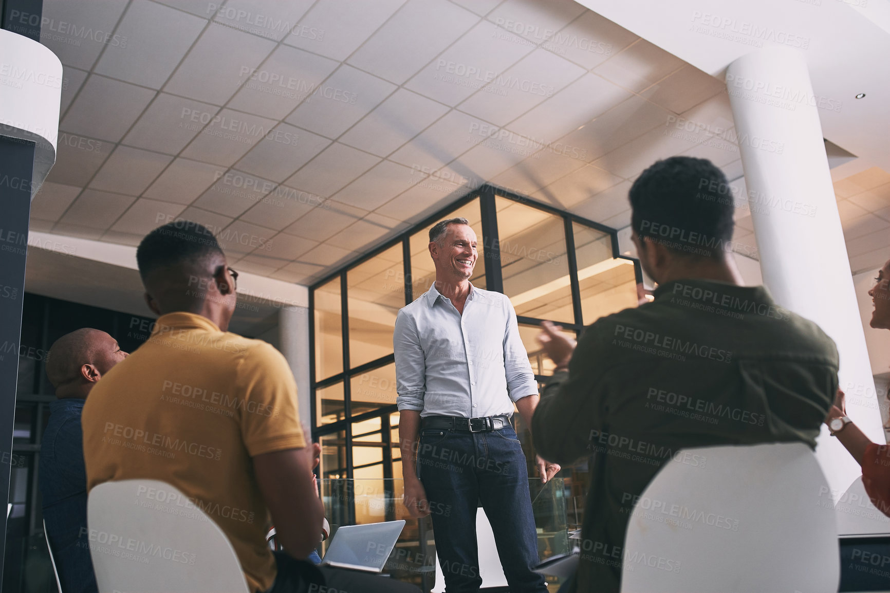 Buy stock photo Shot of a team of staff applauding during a meeting