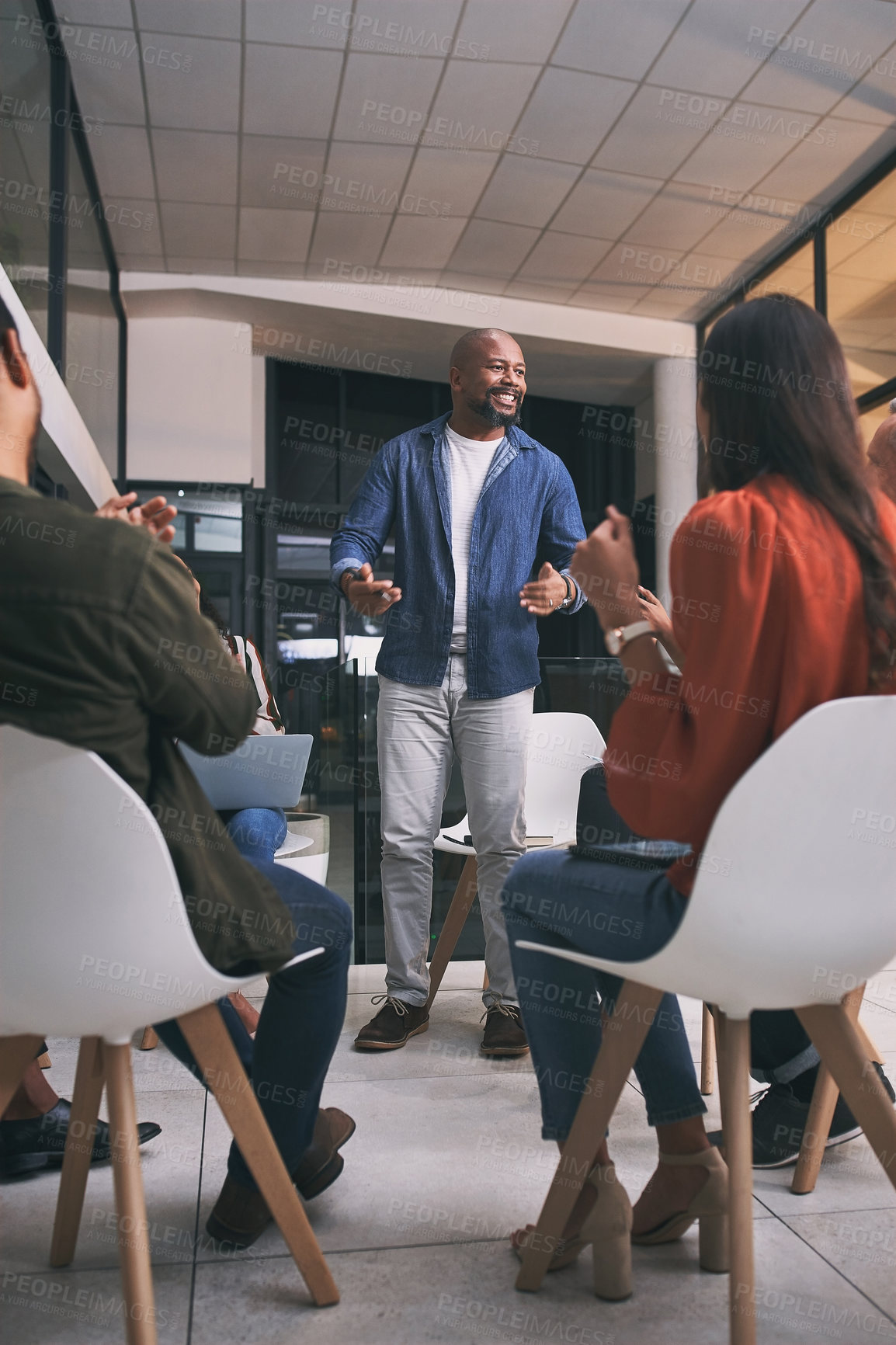 Buy stock photo Shot of a team of staff applauding during a meeting