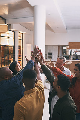Buy stock photo Shot of a team high fiving each other in a office