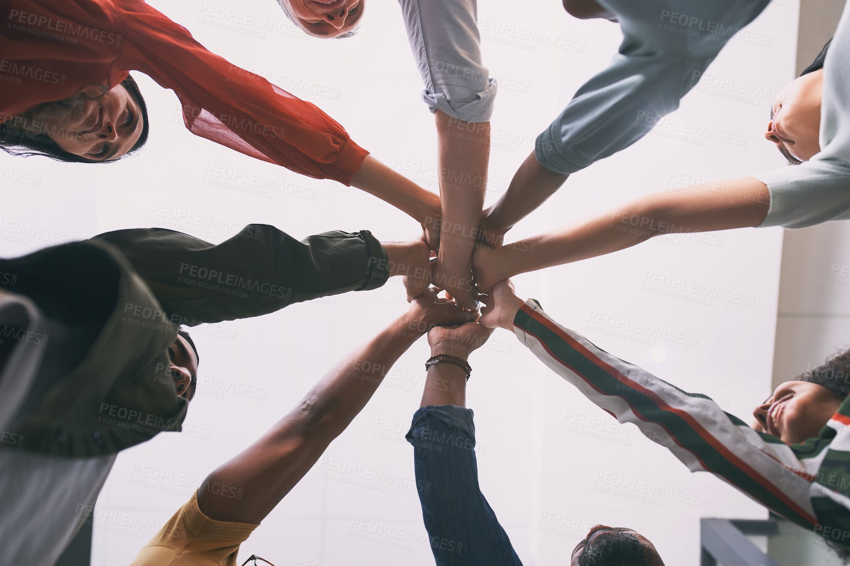 Buy stock photo Shot of a team of business people stacking their hands in motivation