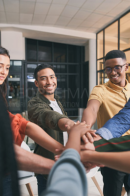 Buy stock photo Shot of a team of business people stacking their hands in motivation