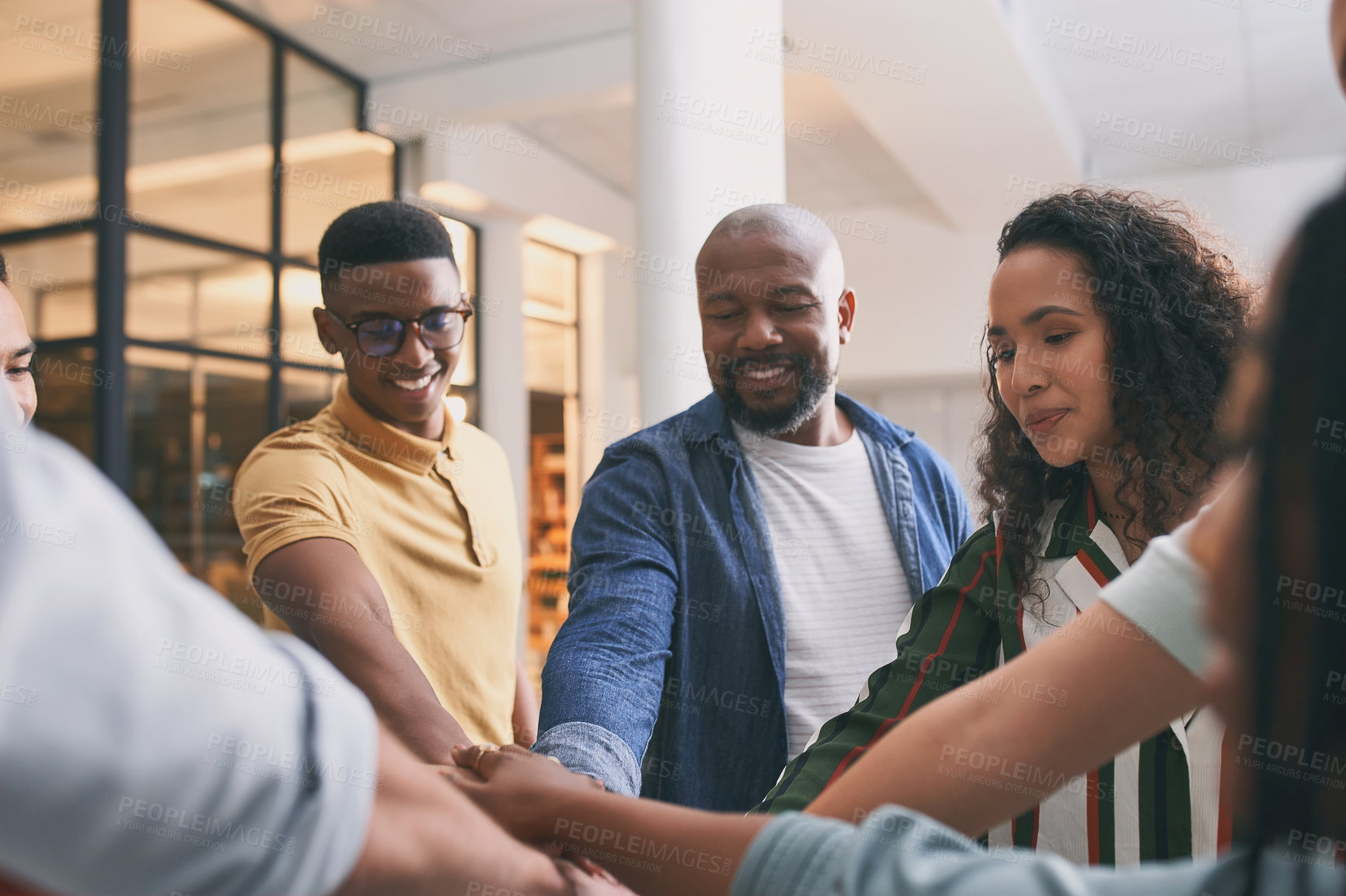 Buy stock photo Shot of a team of business people stacking their hands in motivation