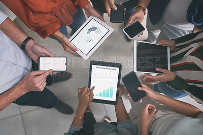Buy stock photo Shot of a unrecognizable team of colleagues using digital tablets and