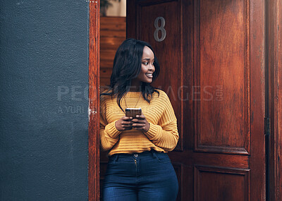 Buy stock photo Doorway, woman and phone for social media, texting and happy while reading message in front of house. Smartphone, influencer and african female online for blog, networking or property app review