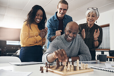 Buy stock photo Shot of a businessman playing chess in his office with his colleagues rooting and watching in the background