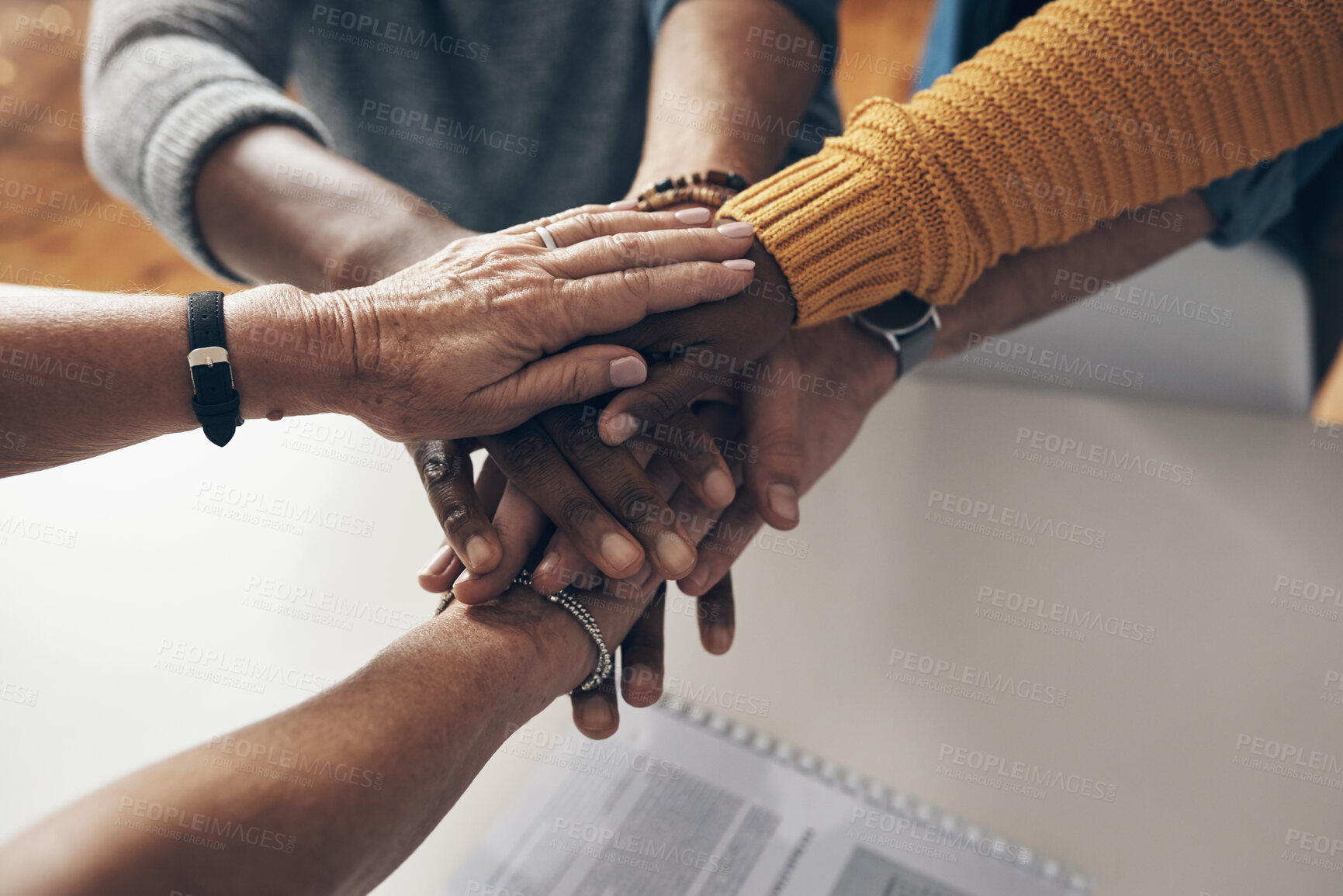 Buy stock photo Shot of a group of unrecognisable businesspeople joining hands together in solidarity inside their office at work