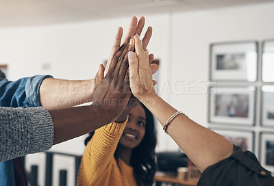 Buy stock photo Shot of a group of businesspeople joining hands together for a high five inside an office