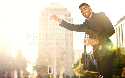 Buy stock photo Shot of a handsome young businessman hailing a cab