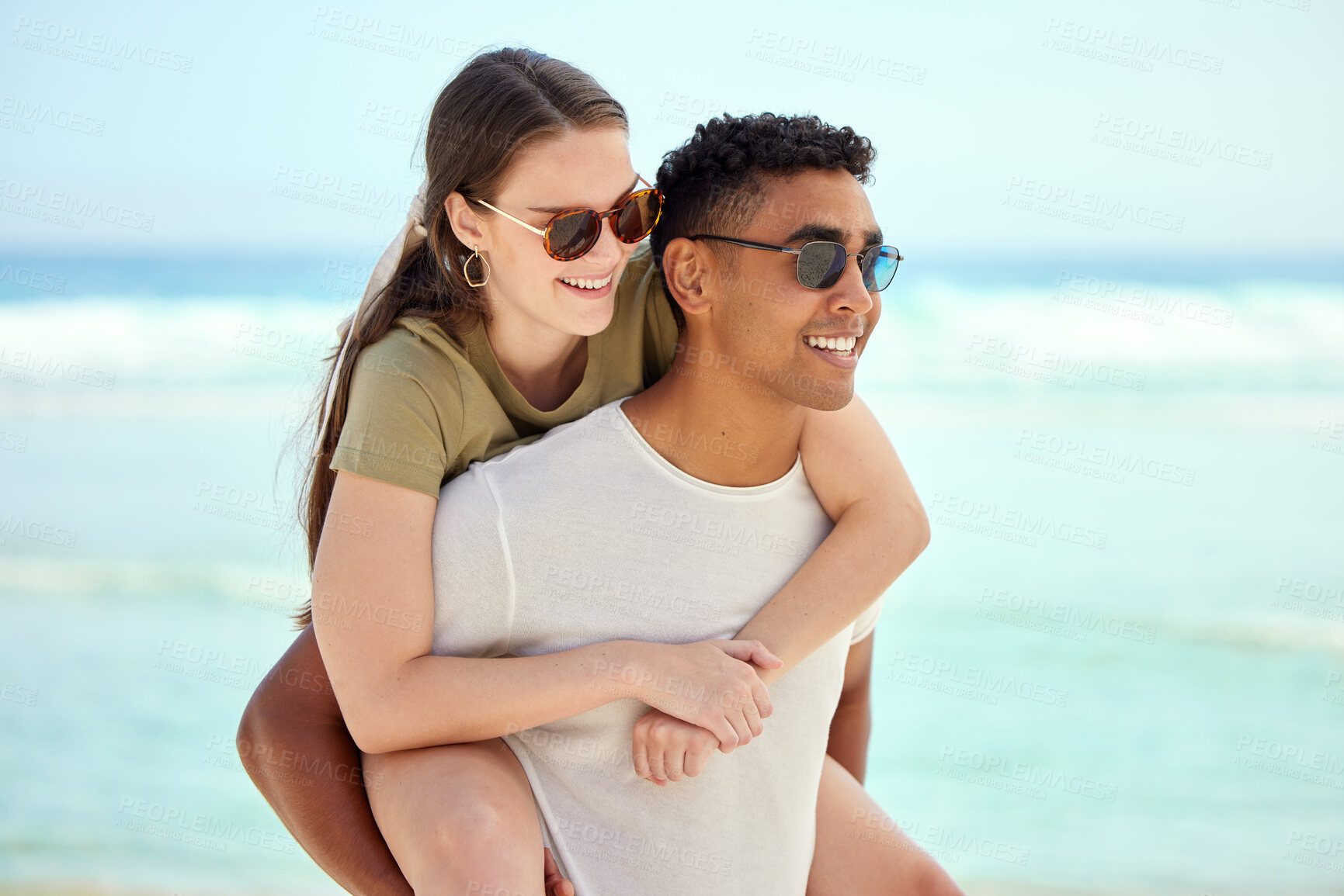 Buy stock photo Shot of a young couple enjoying a day at the beach