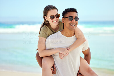 Buy stock photo Shot of a young couple enjoying a day at the beach
