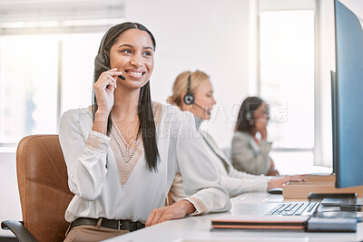 Buy stock photo Cropped shot of an attractive young female call center agent wearing a headset while working in the office with her coworkers