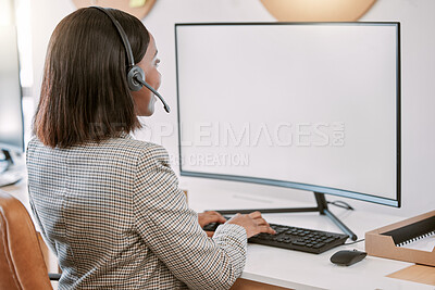 Buy stock photo Rearview shot of a female call center agent wearing a headset while working on her computer in the office