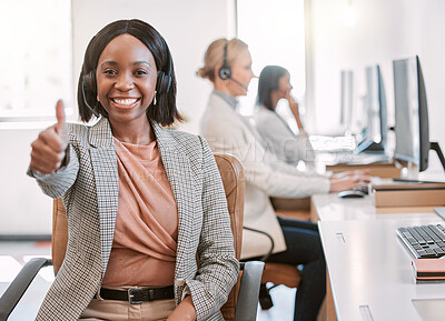 Buy stock photo Cropped portrait of an attractive mature female call center agent wearing a headset and giving thumbs up while working in her office
