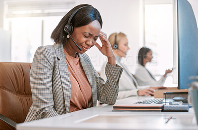Buy stock photo Cropped shot of an attractive mature female call center agent suffering with a headache while working on her computer in the office