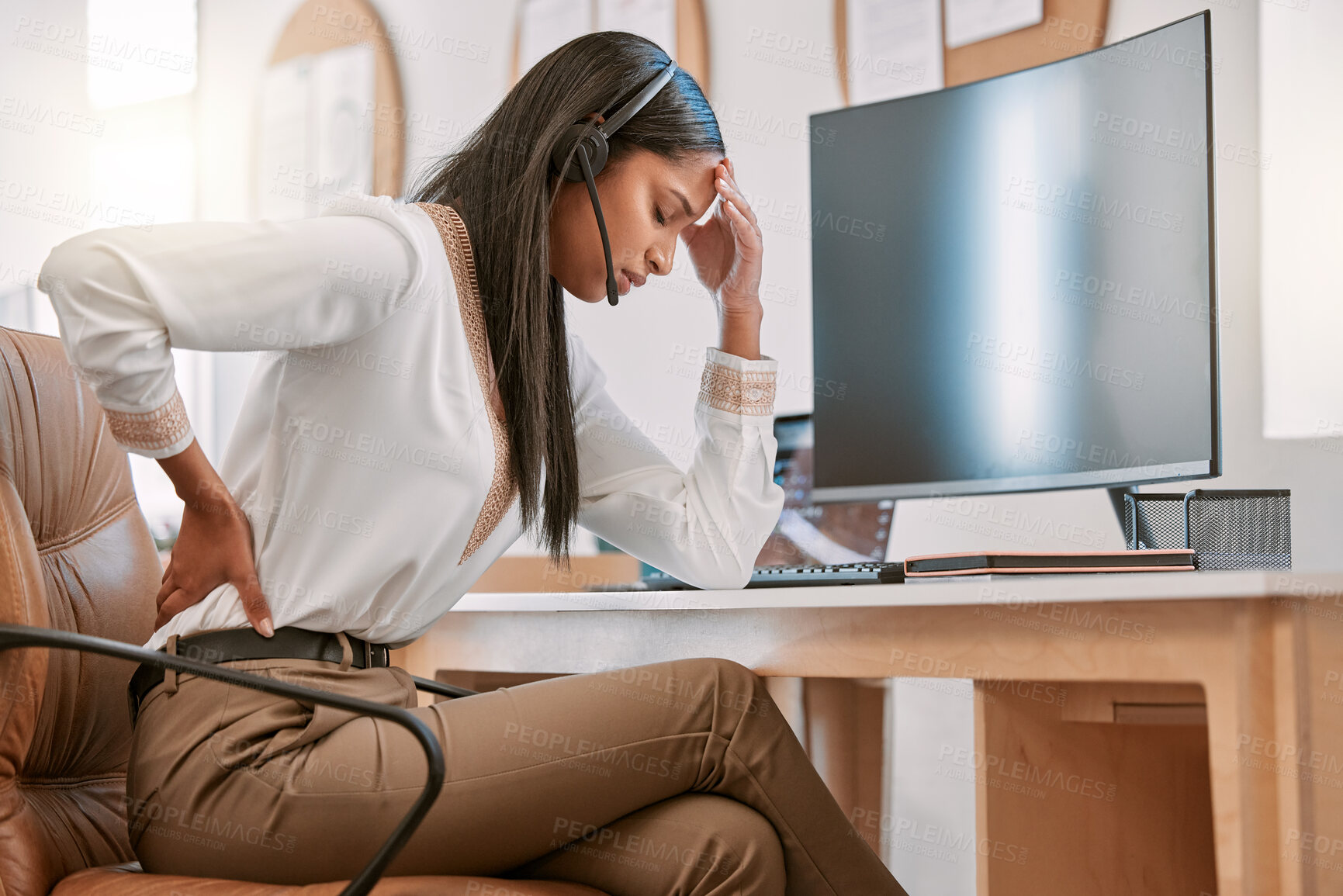 Buy stock photo Cropped shot of an attractive young female call center agent suffering with back pain while working on her computer in the office