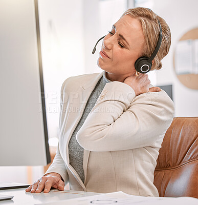 Buy stock photo Cropped shot of an attractive mature female call center agent suffering with neck pain while working on her computer in the office